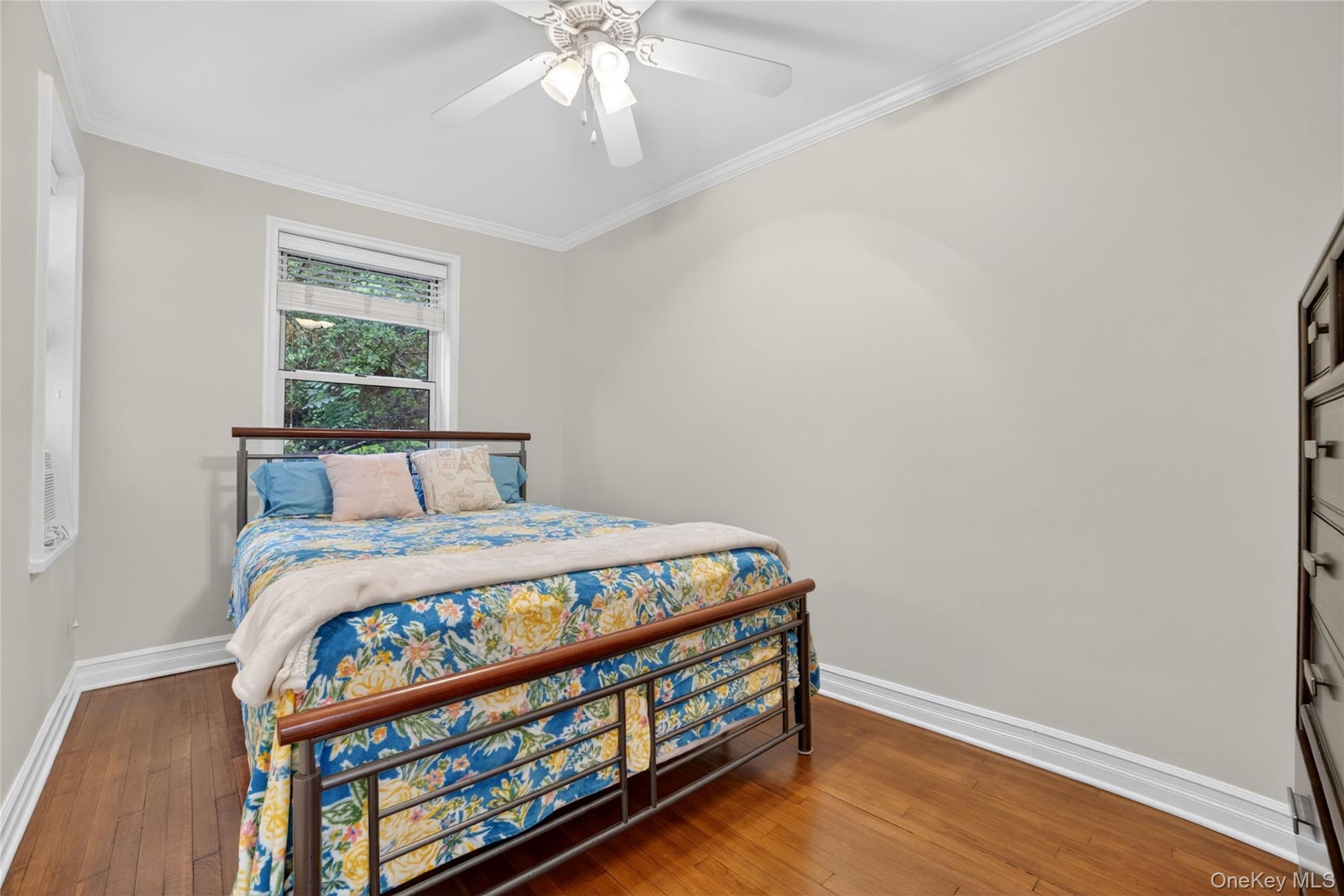 824 Palmer Road, Unit 1F Bronxville, NY 10708 - Photo 17 of 26 a bedroom with a bed and wooden floor