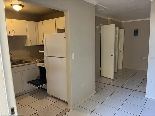a white refrigerator freezer and a stove in a kitchen