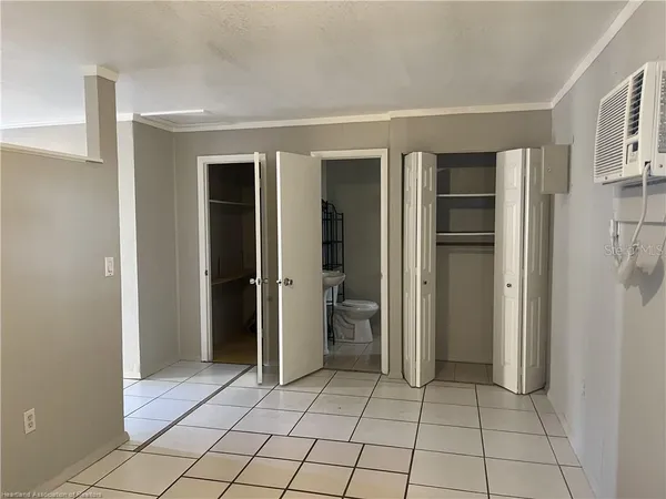 a view of an empty room and closet area