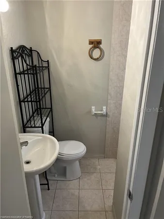 a bathroom with a toilet a sink and a mirror