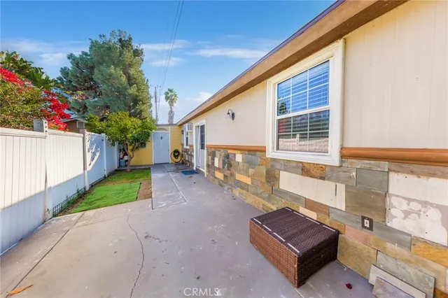 a view of a couches in the patio with a small yard