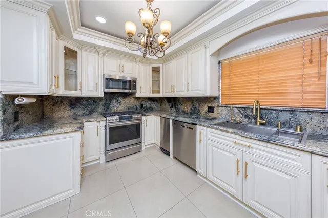 a kitchen with granite countertop a stove sink and cabinets