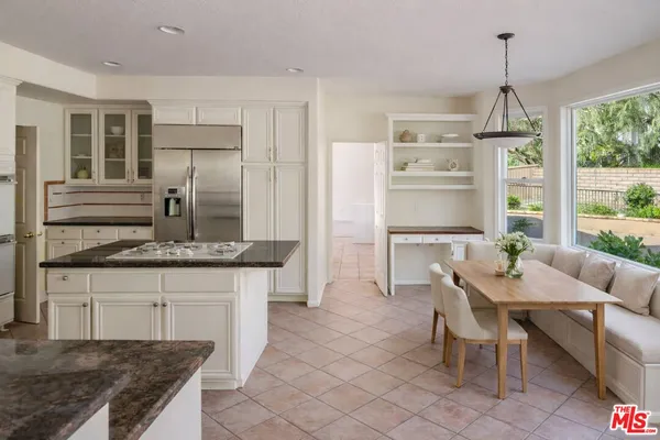 a kitchen with granite countertop a sink stainless steel appliances and cabinets