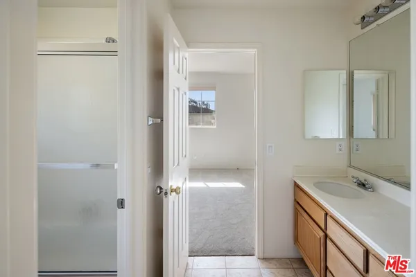a bathroom with a double vanity sink and mirror