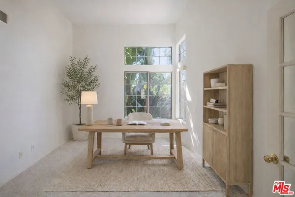 a workspace with furniture and window