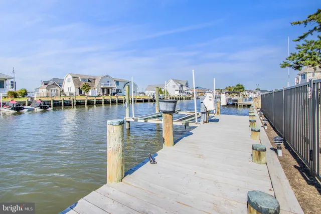 a kitchen with granite countertop a refrigerator and a stove top oven