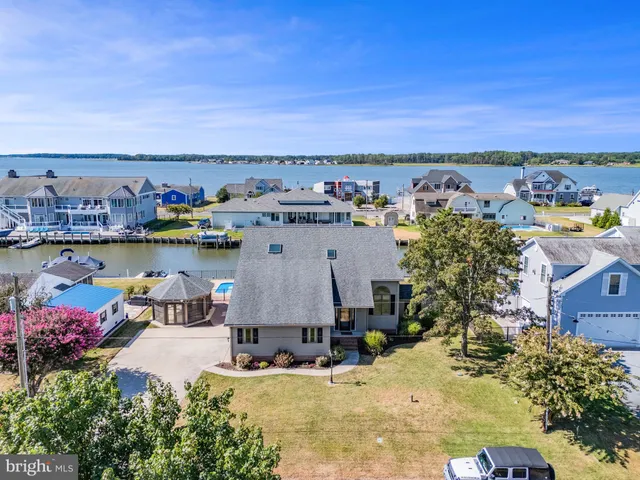 a view of a house with large windows and a garage