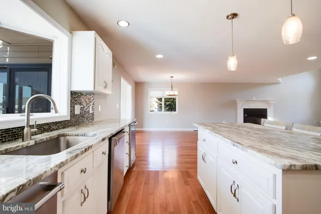 a bathroom with a double vanity sink a mirror a shower and a bathtub