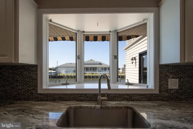 an aerial view of a house with a swimming pool and lake view
