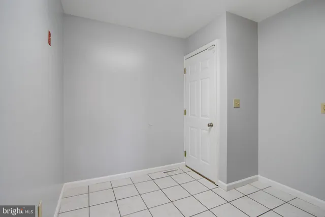 an aerial view of a city with lots of residential buildings ocean and mountain view in back