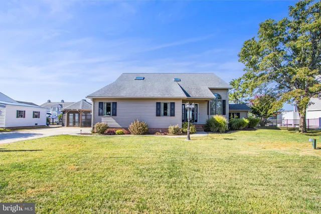 a view of swimming pool with outdoor seating and buildings in the background