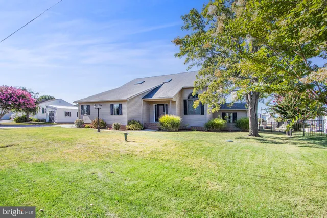 a view of a house with swimming pool and a yard