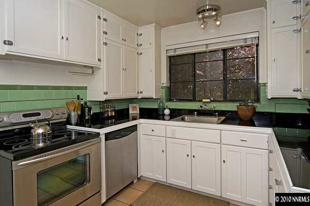 555 Reno Avenue Reno, NV 89509 - Photo 5 of 9 a kitchen with white cabinets and appliances