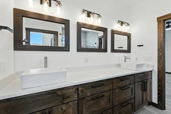 a bathroom with a sink vanity and mirror
