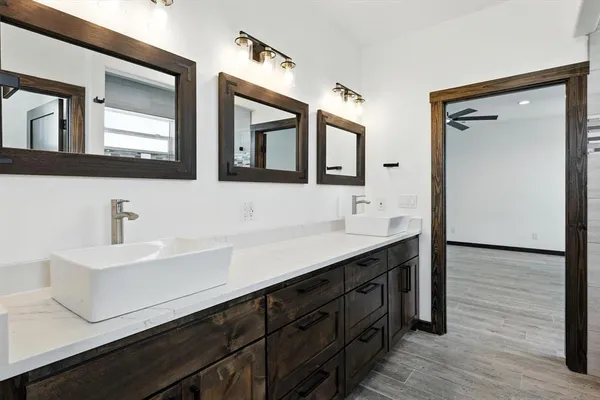 a bathroom with a sink double vanity and a mirror
