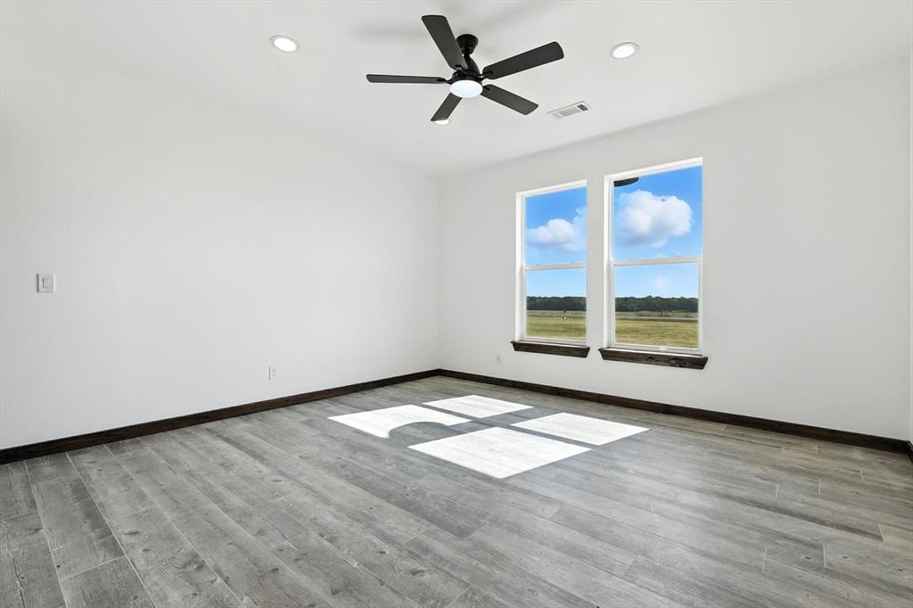 835 Clb Lk Road Whitesboro, TX 76273 - Photo 22 of 33 wooden floor in an empty room with a window