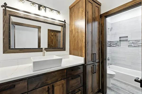 a bathroom with a sink a mirror and a bathtub