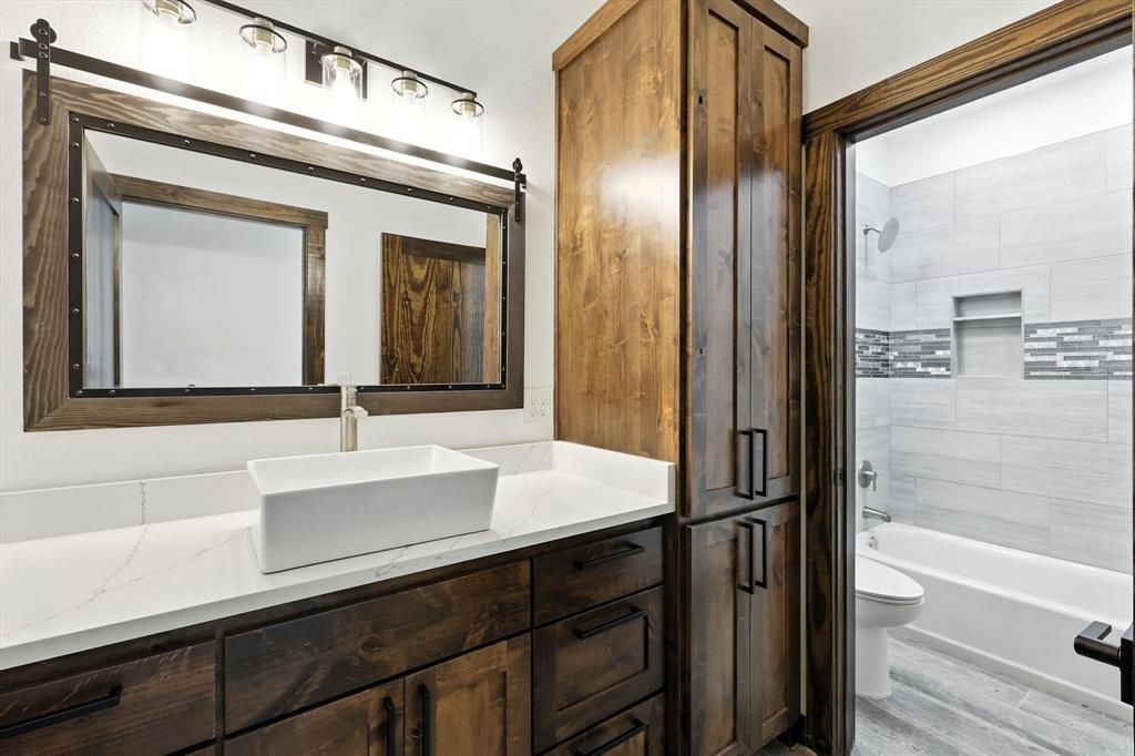 835 Clb Lk Road Whitesboro, TX 76273 - Photo 24 of 33 a bathroom with a sink a mirror and a bathtub