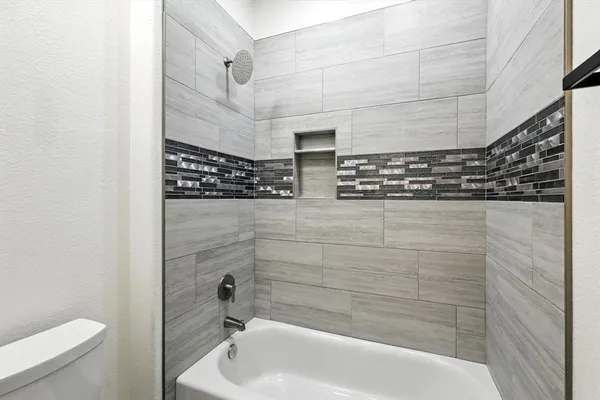 a bathroom with a shower and a toilet