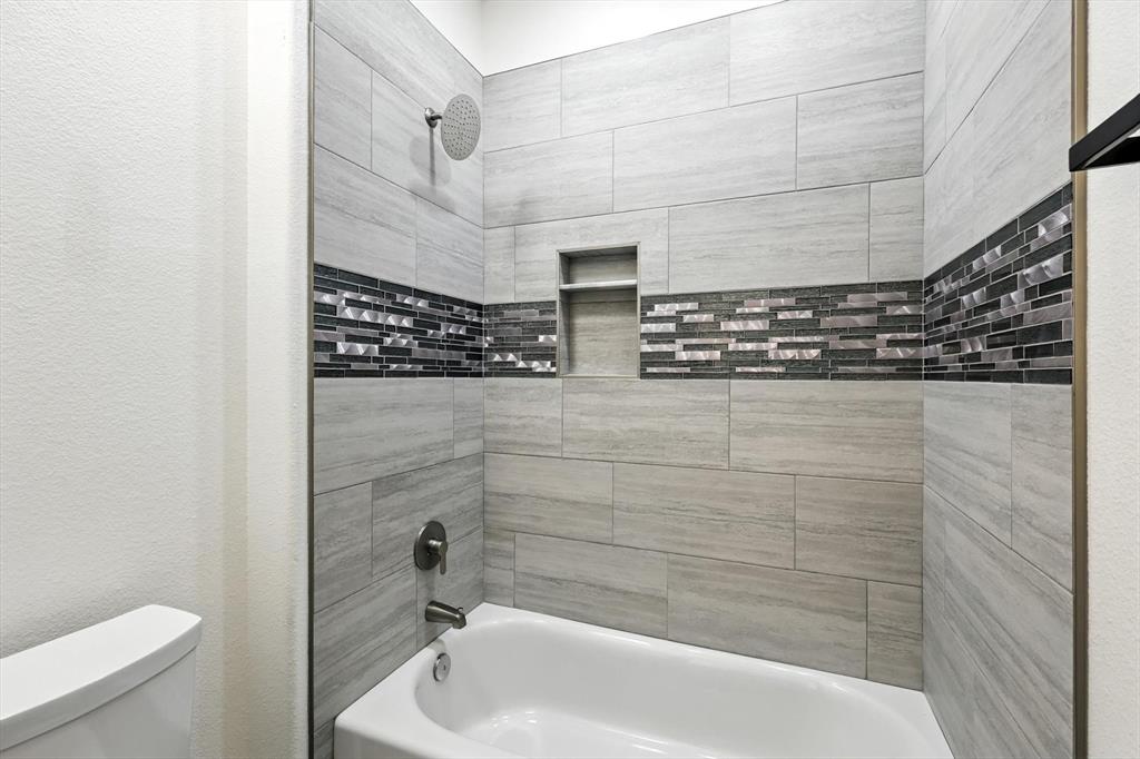 835 Clb Lk Road Whitesboro, TX 76273 - Photo 25 of 33 a bathroom with a shower and a toilet