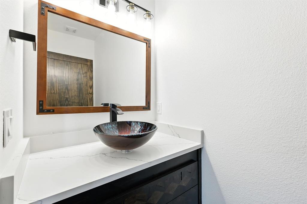 835 Clb Lk Road Whitesboro, TX 76273 - Photo 28 of 33 a bathroom with a sink and a mirror