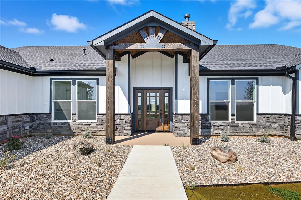 835 Clb Lk Road Whitesboro, TX 76273 - Photo 3 of 33 a front view of a house with a yard