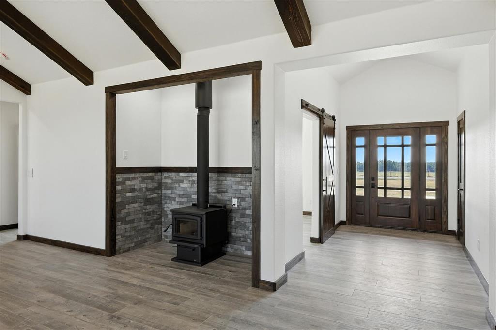 835 Clb Lk Road Whitesboro, TX 76273 - Photo 4 of 33 a view of an empty room with window and wooden floor