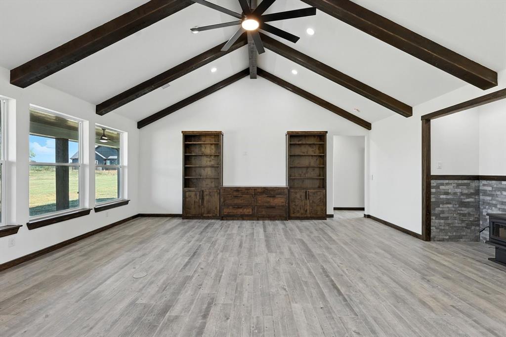 835 Clb Lk Road Whitesboro, TX 76273 - Photo 5 of 33 a view of a livingroom with wooden floor and a ceiling fan