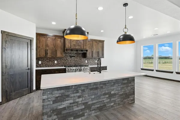 a view of a kitchen with a sink a refrigerator and a counter top space