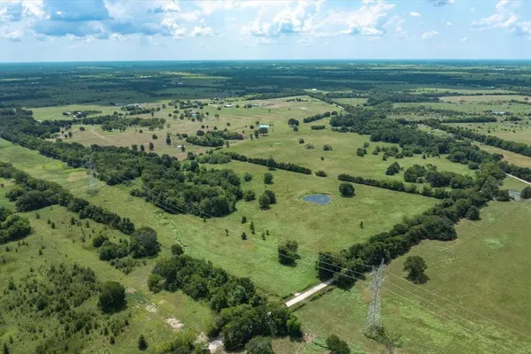 a view of a field with an ocean
