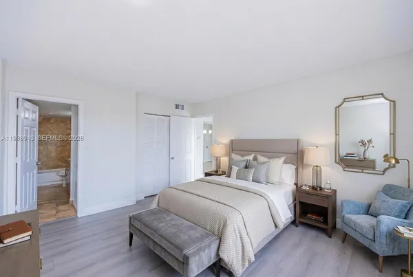 a bedroom with bed and wooden floor