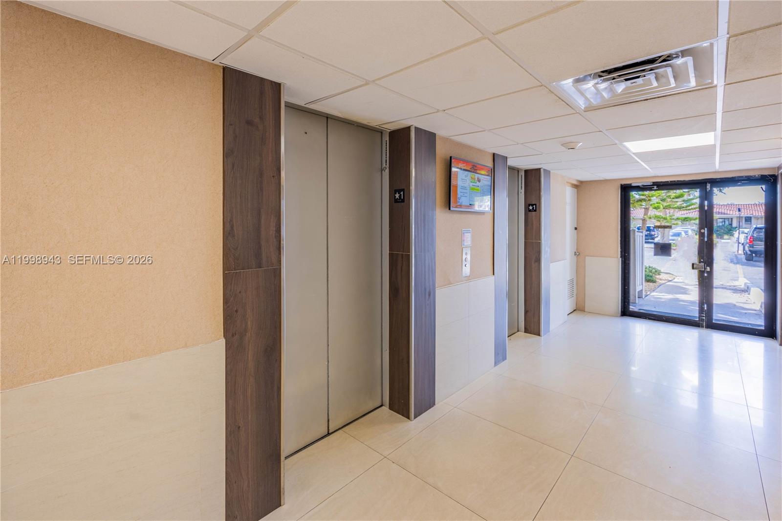 4164 Inverrary Drive, Unit 812 Lauderhill, FL 33319 - Photo 9 of 21 a view of a hallway with an empty room and windows