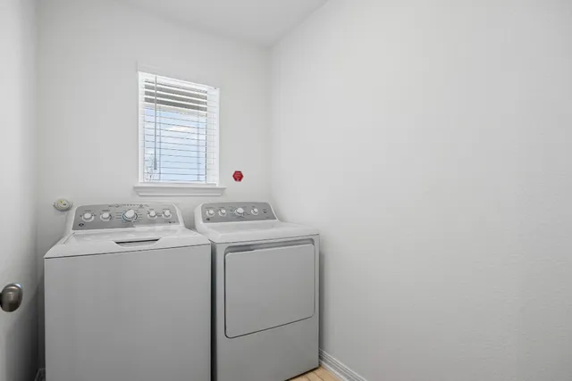 a bathroom with a granite countertop bathtub shower sink vanity mirror and toilet