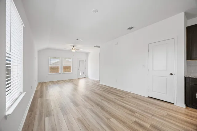 a kitchen with granite countertop a sink stove and cabinets
