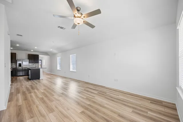 a view of a livingroom with a furniture wooden floor and a ceiling fan