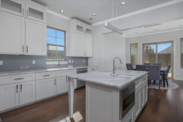 a kitchen that has a sink and a stove in it