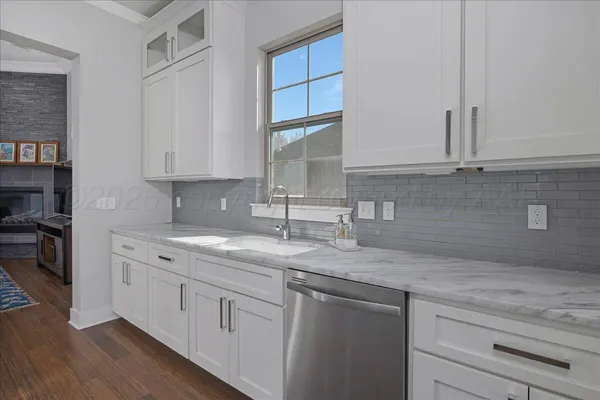 a kitchen with a sink cabinets and window