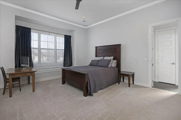 a bedroom with a bed and two windows