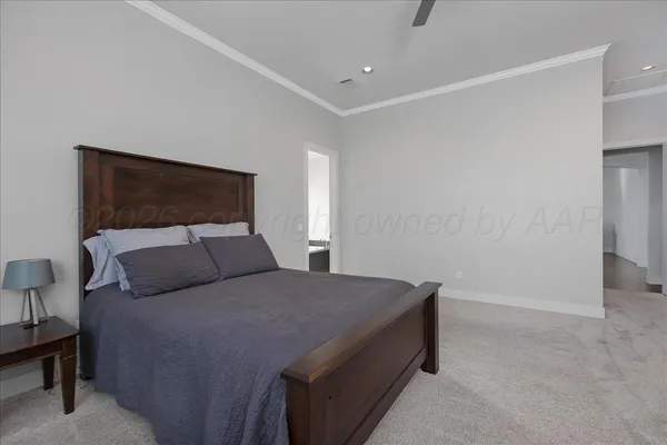 a bedroom with a bed and a night stand