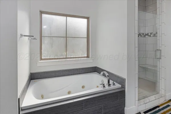 a bathroom with a tub and a window