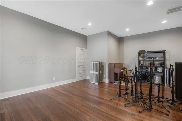 a view of a room with lots of wooden furniture