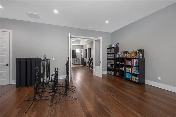 a view of a hallway with wooden floor and furniture