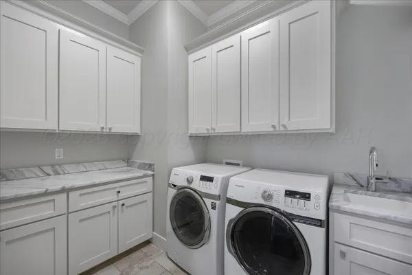 a view of a storage and utility room with washer and dryer