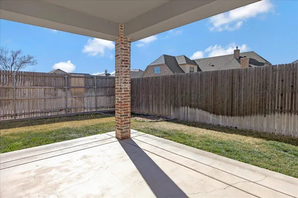 a view of a backyard with a fence
