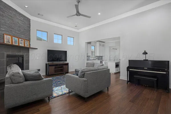 a living room with furniture a flat screen tv and a fireplace