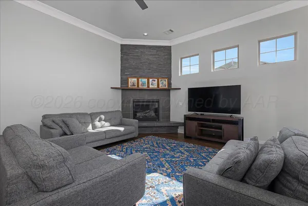 a living room with furniture a flat screen tv and a fireplace
