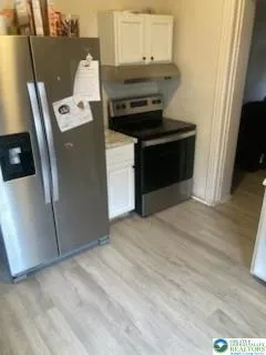 a kitchen with a refrigerator and a stove