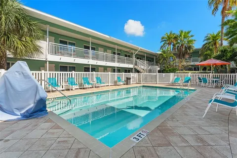 a view of swimming pool with a lounge chairs