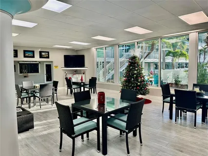 a dining room with furniture window and wooden floor