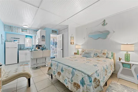 a bedroom with a bed a table and chair